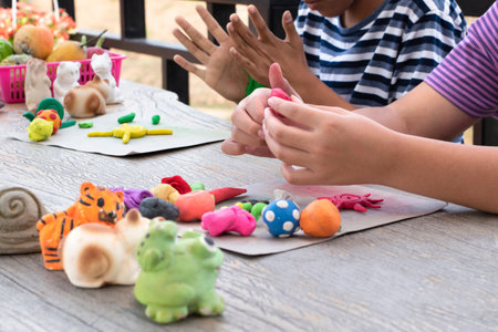 Children play with clay and plasticine at the playground. Early development and creativity concept.