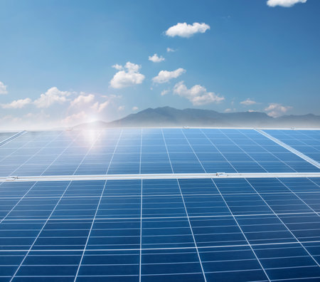 Solar panels with blue sky and mountain background. Alternative energy source.