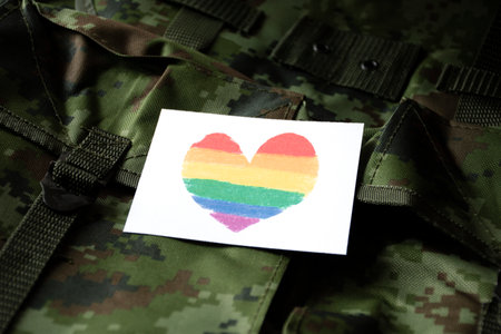 Military uniform with heart symbol and card. Symbol of LGBT community.