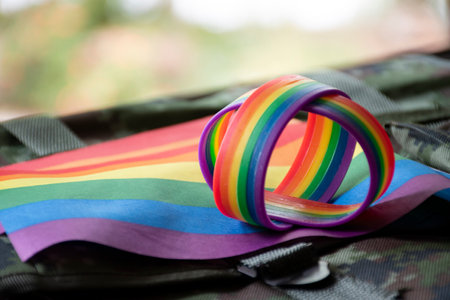Rainbow ribbon on a military backpacks. Selective focus.の写真素材