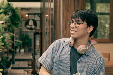 Portrait of young handsome Asian hipster man with eyeglasses
