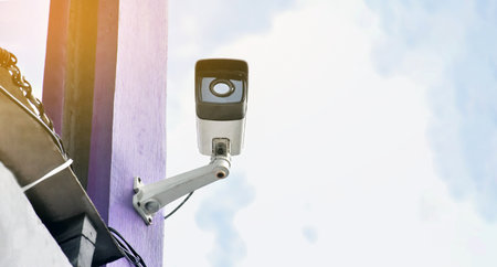CCTV security camera or surveillance system with blue sky and cloud background