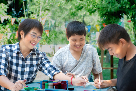 Group of asian children drawing pictures together in the park.の写真素材