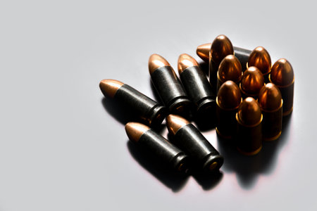 9mm pistol gun bullets on gray background, soft focus, new edited, concept for shooting sports and...