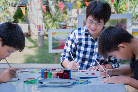 Group of asian children painting on the table in the park.の写真素材