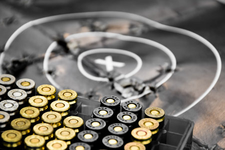 9mm pistol gun bullets in a black cartridge with a black target on the dark background, new edited,...