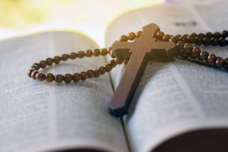 Wooden rosary beads on the bible with shallow depth of fieldの写真素材
