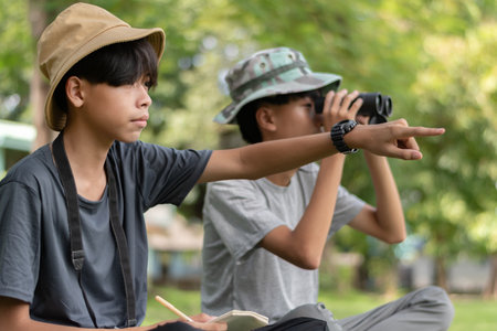 Asian boy and boy using binoculars to take a photo.の写真素材