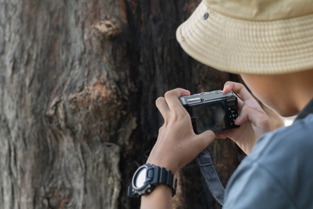 Photographer taking a picture of a tree. Selective focus.