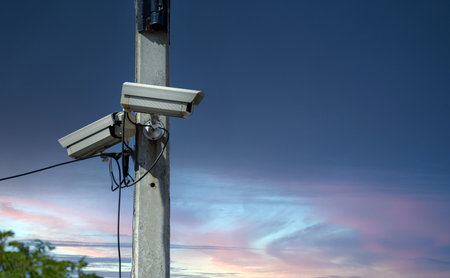 security camera on pole with twilight sky background, security and safety concept