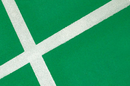 White line on the green tennis court floor. Abstract background and texture.の写真素材