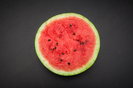 A half of fresh jucie red watermelon on black background.の写真素材