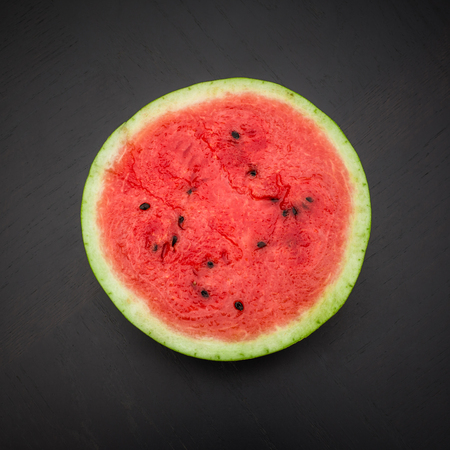 A half of fresh jucie red watermelon on black background.の写真素材