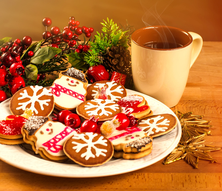 Mug with hot drink and Christmas cookies. Background with a cup of chocolate, tea or coffee, festive decoration. Winter holiday concept. Beautiful cookies and bakery with cup of steaming beverage.の写真素材