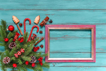 Christmas light blue or green wood grunge background and frame for wishes. Top view, fir twigs,...