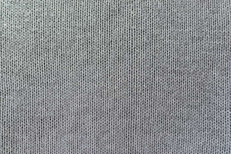 Knitted pattern closeup. Soft sweater texture, detailed yarn background. Natural woolen fabric, a...