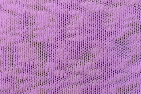 Knitted pattern closeup. Soft sweater texture, detailed yarn background. Natural woolen fabric, a fragment of a jersey pullover. Trendy backdrop for print, web design.の写真素材