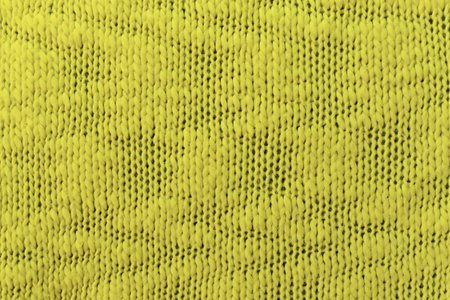Knitted pattern closeup. Soft sweater texture, detailed yarn background. Natural woolen fabric, a fragment of a jersey pullover. Trendy backdrop for print, web design.の写真素材