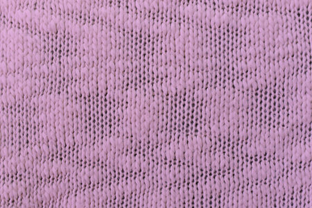 Knitted pattern closeup. Soft sweater texture, detailed yarn background. Natural woolen fabric, a fragment of a jersey pullover. Trendy backdrop for print, web design.の写真素材