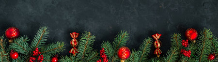 Christmas dark grunge horizontal background, top view. Fir twigs, red golden berries, baubles. Winter holidays, New Year decoration, pine tree branches, snow covered cones, flat lay, copy space.の写真素材