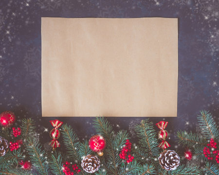 Christmas dark lilac grunge horizontal background, top view. Fir twigs, red golden berries, baubles, New Year decoration. Aged paper, copy-space for wishes.の写真素材