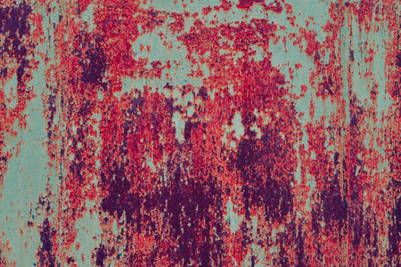 Rusty metal painted background. Rust spots and streaks on stained metal surface. Grunge industrial colored steel texture. Scratched corroded aged damaged backdrop with rustic vintage worn details.の写真素材