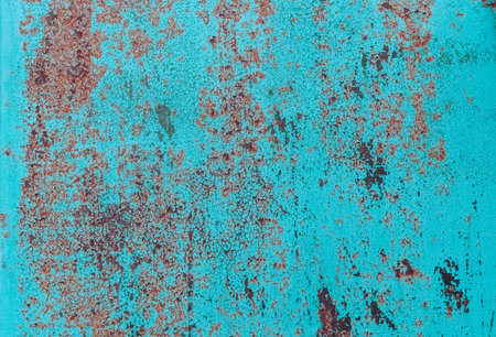 Rusty metal painted background. Rust spots and streaks on stained metal surface. Grunge industrial colored steel texture. Scratched corroded aged damaged backdrop with rustic vintage worn details.の写真素材