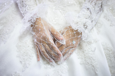 Woman in white wedding dress, bride hands in white bride gloves. Traditional Islamic hijab wedding dresses. Muslim brides who spent their wedding day wearing the most incredible veils called hijabs.の写真素材