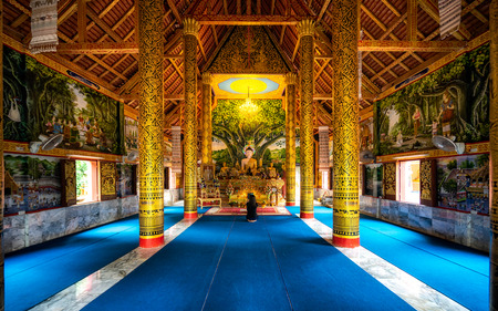 Golden Buddha statue at temple of Thailand. Large prayer hall. Peaceful prayers and meditation inside. The famous beautiful Thai art.のeditorial素材