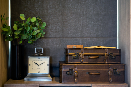 Clock and old leather suitcase in the bedroom. Bedroom modern design. Interior design.の写真素材