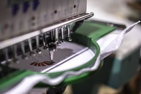 Automatic industrial sewing machine by digital pattern. Modern textile industry.