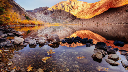 Mountain lake in autumn with reflection of the mountains in the waterの写真素材