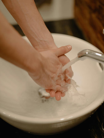 Washing hands with soap in the bathroom. Hygiene concept.の写真素材
