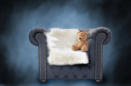 Comfortable armchair with fur and teddy bear on blue backgroundの写真素材