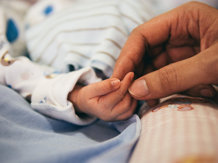Newborn baby in the hands of his father. Selective focus.の写真素材
