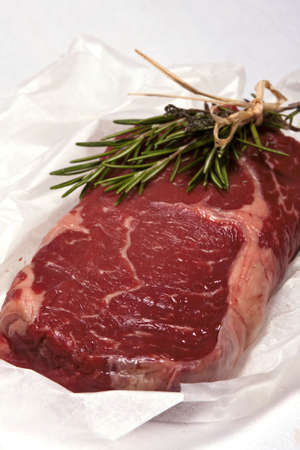 Piece of raw meat with herbs de Provence prepared for grill  の写真素材