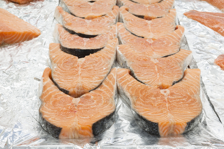 raw salmon fillet on aluminium foilの写真素材
