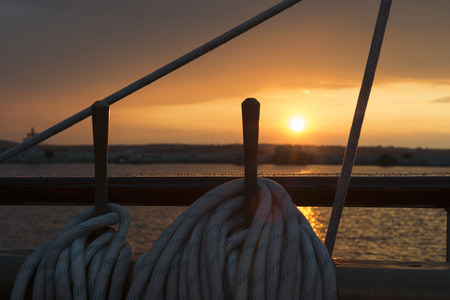 sailing vessel ropes against sunsetの写真素材