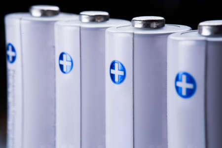 Several AA batteries in perspective closeup view on white background