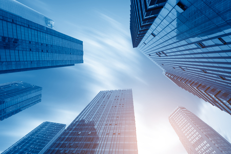 Common modern business skyscrapers, high-rise buildings, architecture raising to the sky, sun. Concepts of financial, economics, future etc.の写真素材