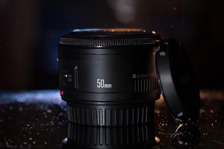 Camera lens isolated on dark background の写真素材
