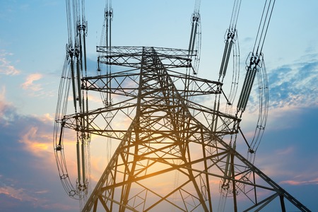 Pylon and transmission power line in sunsetの写真素材