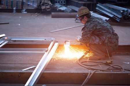 industrial worker welding sparking