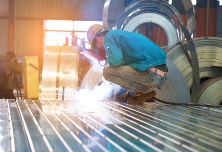 Electric wheel grinding on steel structure in factoryの写真素材