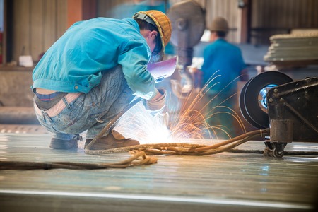 An industrial background. Welder in a factoryの写真素材
