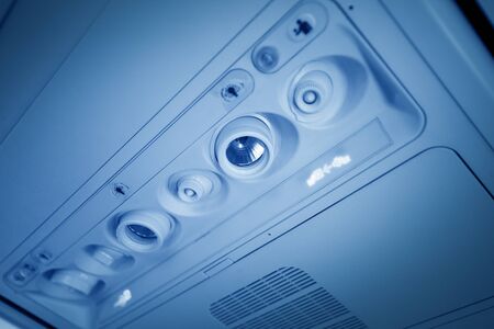 Cabin inside the aircraft, lights, air condition and signs panel above the seatの写真素材