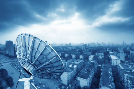 In the city night background large satellite antennaの写真素材