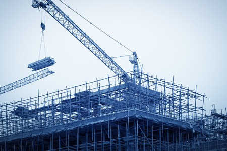 Construction site with cranes on sky backgroundの写真素材