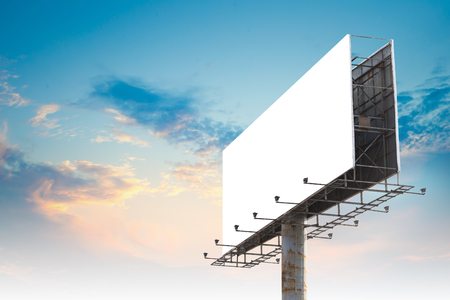 Blank Outdoor Advertising Billboard Hoarding Against Cloudy Sky, White Copy Space for Mock Up Design or Marketing Messageの写真素材
