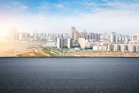 empty floor with backdrop on modern cityscape at sunrise timeの写真素材